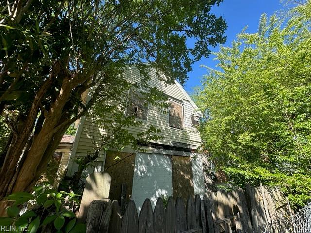 view of home's exterior featuring fence