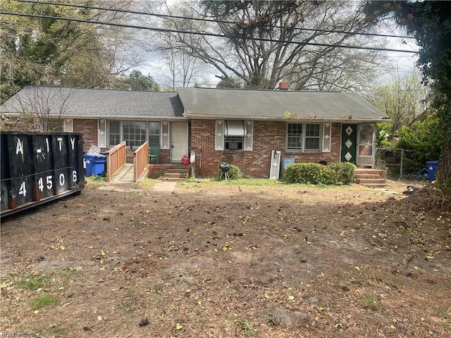 view of front facade featuring fence and brick siding