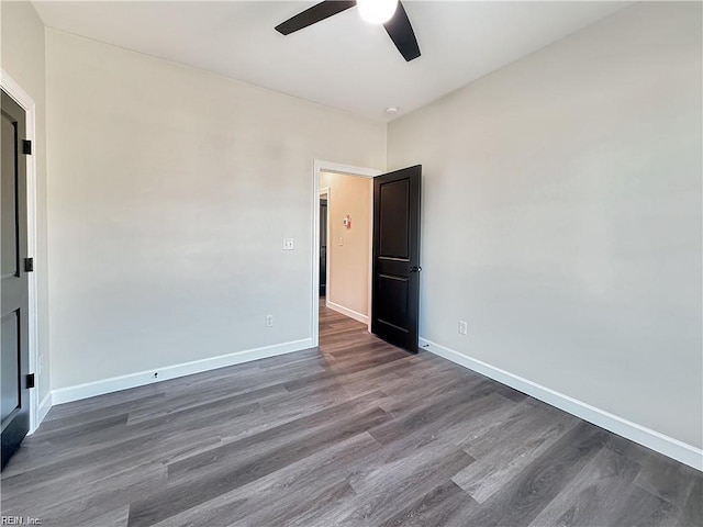 unfurnished room featuring baseboards, wood finished floors, and a ceiling fan