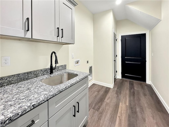 laundry area featuring a sink, electric dryer hookup, baseboards, hookup for a washing machine, and dark wood-type flooring