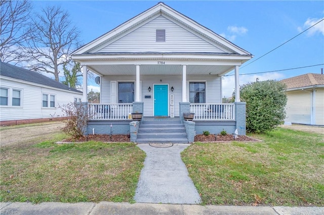 view of front of home featuring a porch and a front lawn