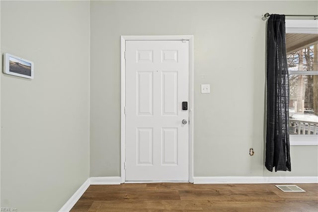 interior space with visible vents, wood finished floors, and baseboards