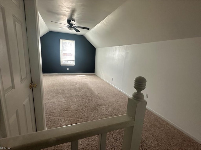 additional living space with baseboards, a ceiling fan, carpet floors, and lofted ceiling