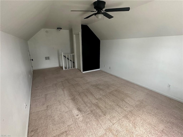bonus room featuring ceiling fan, vaulted ceiling, and light carpet