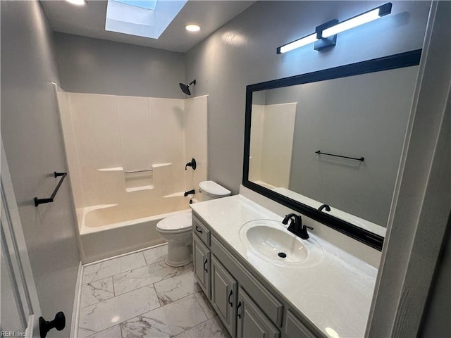 full bathroom with vanity, toilet, marble finish floor, tub / shower combination, and a skylight