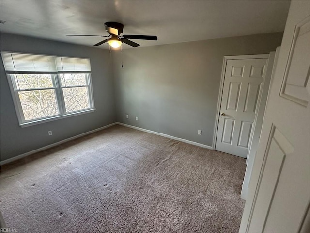 unfurnished bedroom with baseboards, a ceiling fan, and carpet floors