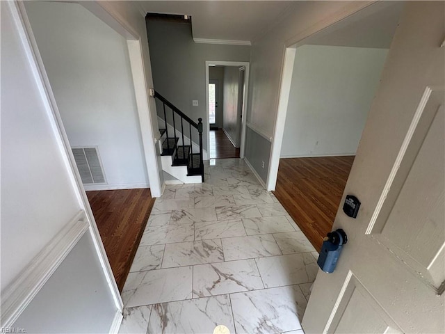 entryway featuring stairway, marble finish floor, ornamental molding, baseboards, and visible vents