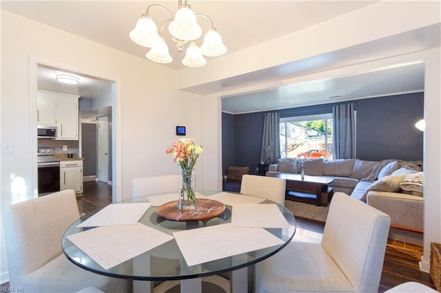 dining room featuring a chandelier and dark wood-type flooring