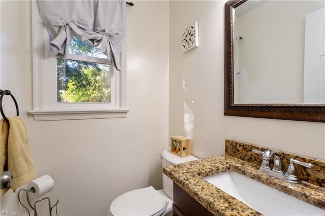 bathroom featuring vanity and toilet