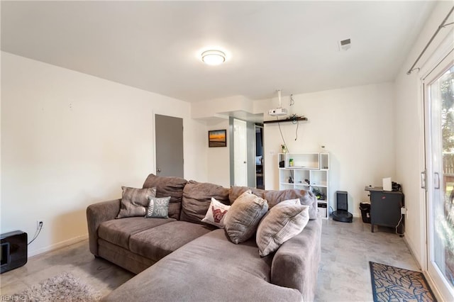 living area featuring baseboards and visible vents