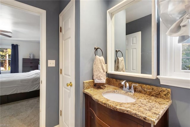 bathroom with vanity, ceiling fan, and a healthy amount of sunlight