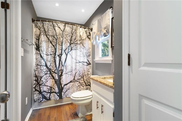 full bath with vanity, wood finished floors, curtained shower, toilet, and recessed lighting