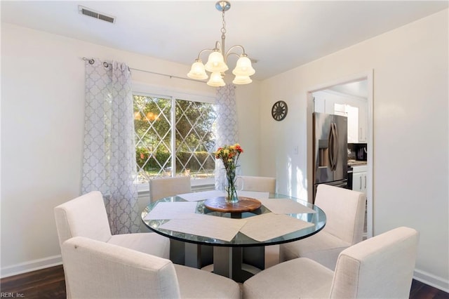 dining area with visible vents, baseboards, a chandelier, and dark wood-style floors