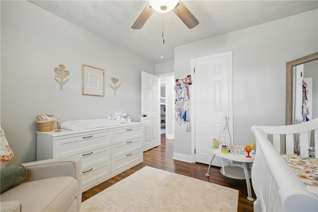 bedroom with ceiling fan and dark wood-style floors