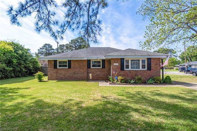 single story home with a front yard and brick siding