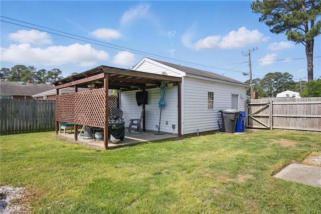 view of outdoor structure with a fenced backyard and a gate
