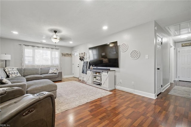 living area featuring attic access, recessed lighting, a ceiling fan, baseboards, and wood finished floors