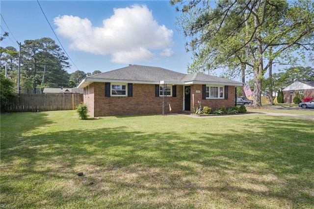 ranch-style home featuring fence, a front lawn, and brick siding