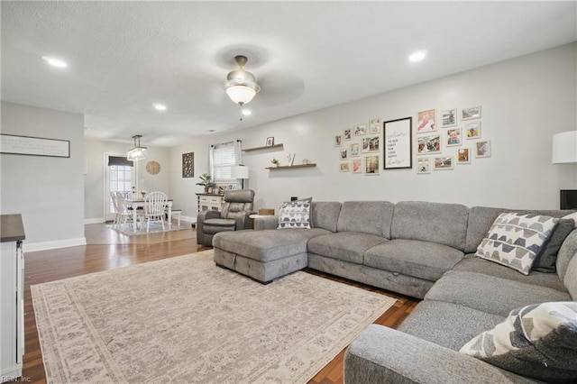 living room featuring a ceiling fan, recessed lighting, and dark wood-style floors