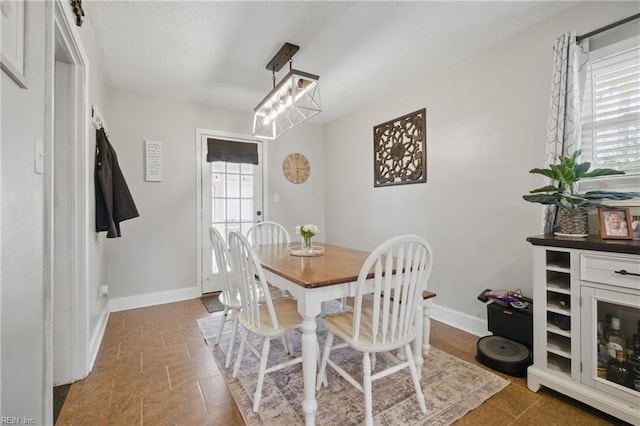 dining space with a wealth of natural light and baseboards