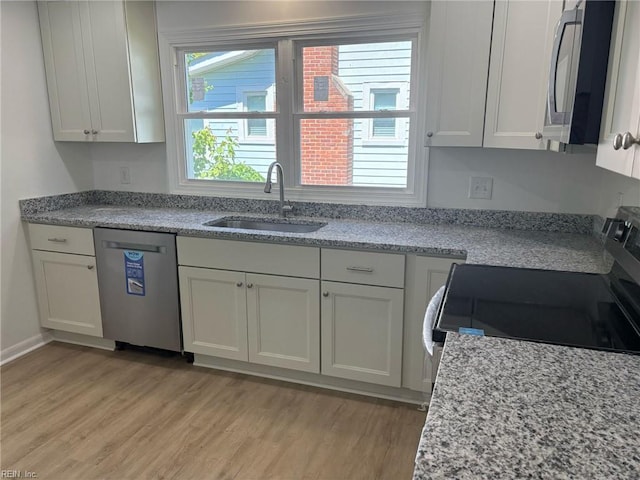 38 W Sherwood Ave, Hampton, VA 23663 - kitchen with white cabinets, appliances with stainless steel finishes, light wood-style flooring, and a sink