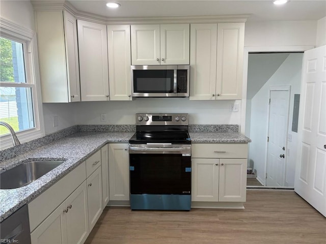 38 W Sherwood Ave, Hampton, VA 23663 - kitchen featuring light stone countertops, stainless steel appliances, light wood-style flooring, and a sink