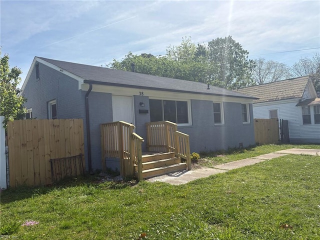 38 W Sherwood Ave, Hampton, VA 23663 - rear view of property featuring brick siding, a yard, and fence