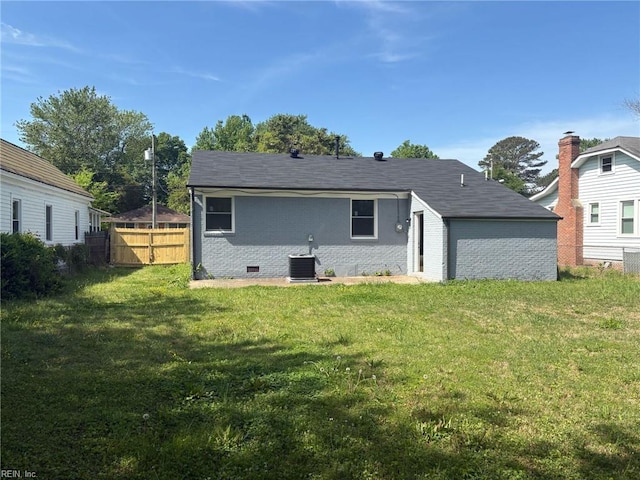 38 W Sherwood Ave, Hampton, VA 23663 - rear view of property featuring brick siding, fence, central air condition unit, crawl space, and a lawn