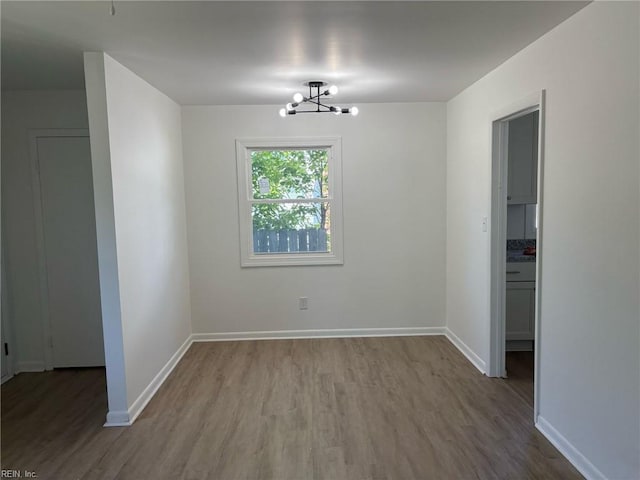 38 W Sherwood Ave, Hampton, VA 23663 - unfurnished dining area featuring a notable chandelier, wood finished floors, and baseboards