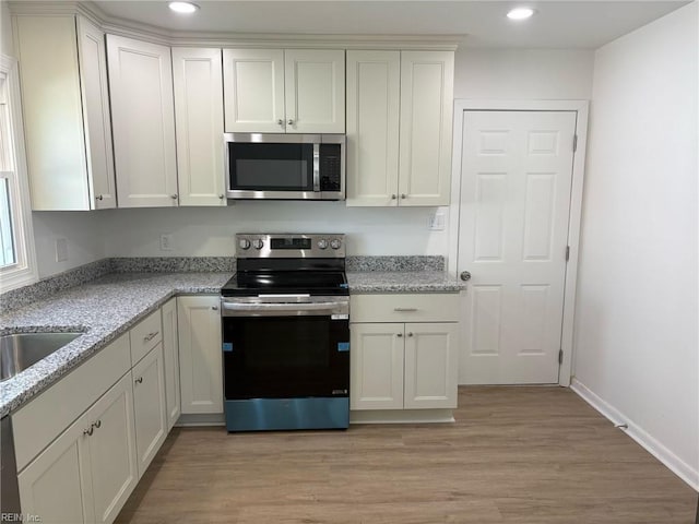 38 W Sherwood Ave, Hampton, VA 23663 - kitchen with recessed lighting, light stone countertops, stainless steel appliances, and light wood-style floors