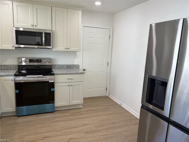 38 W Sherwood Ave, Hampton, VA 23663 - kitchen with recessed lighting, light stone countertops, light wood-style flooring, baseboards, and appliances with stainless steel finishes