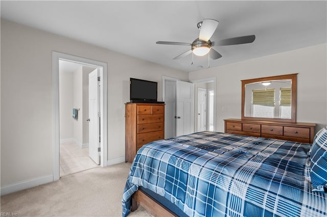 bedroom featuring baseboards, light colored carpet, and ceiling fan