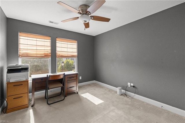 office space with ceiling fan, visible vents, light carpet, and baseboards