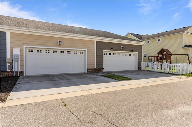 multi unit property with concrete driveway, brick siding, and fence