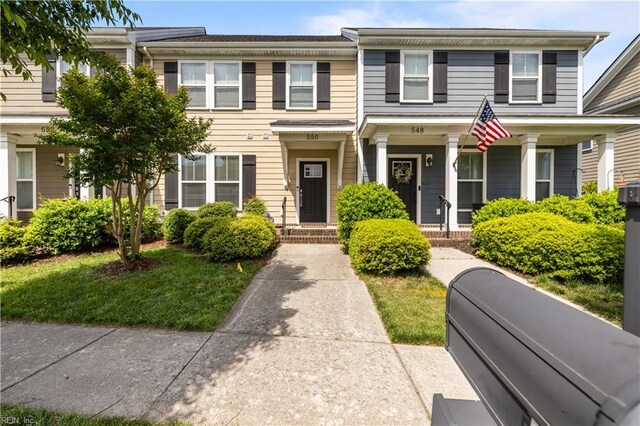 townhome / multi-family property featuring a porch