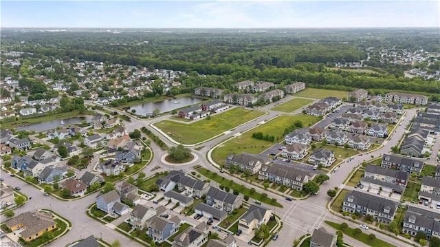 bird's eye view with a residential view, a view of trees, and a water view