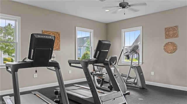 workout area with a healthy amount of sunlight, baseboards, and ceiling fan