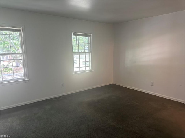 2226 Windom Pl, Virginia Beach, VA 23454 - unfurnished room with healthy amount of natural light, baseboards, and dark colored carpet