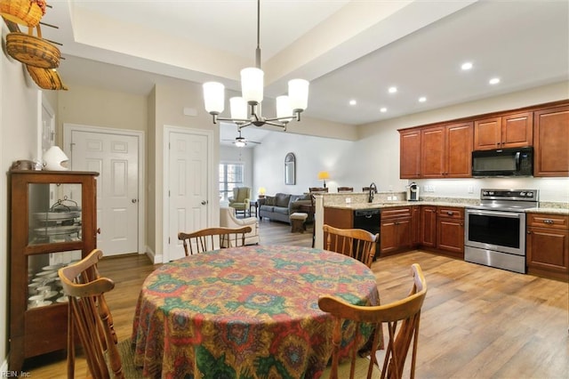 dining area featuring light wood-style floors, baseboards, recessed lighting, and a chandelier