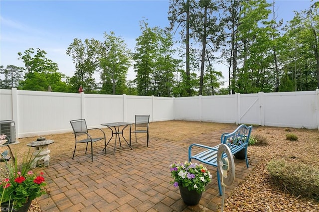 view of patio with a fenced backyard and central air condition unit