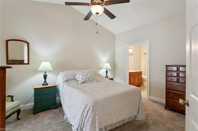 bedroom featuring ceiling fan, connected bathroom, light colored carpet, baseboards, and lofted ceiling