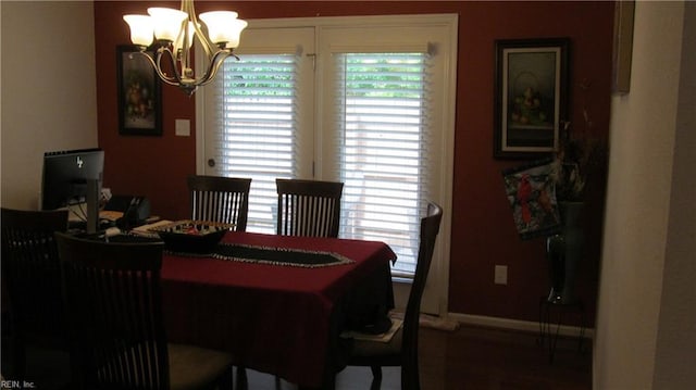 dining room with a wealth of natural light, a notable chandelier, and baseboards