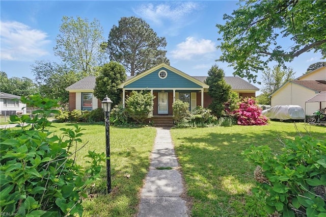 view of front of home with brick siding and a front lawn