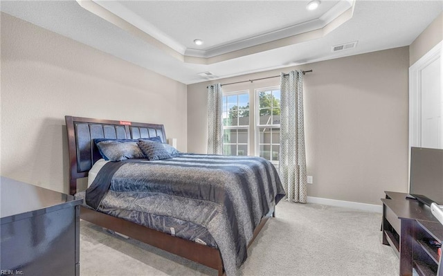 bedroom featuring light carpet, recessed lighting, baseboards, a tray ceiling, and visible vents