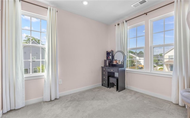 home office with baseboards, a wealth of natural light, carpet, and visible vents