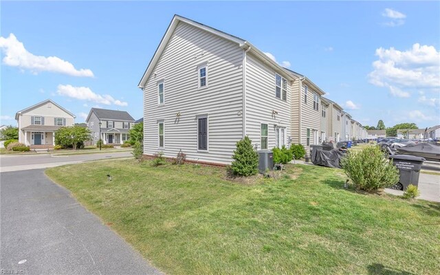 view of property exterior featuring a yard and a residential view