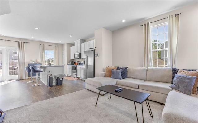 living room with recessed lighting and wood finished floors