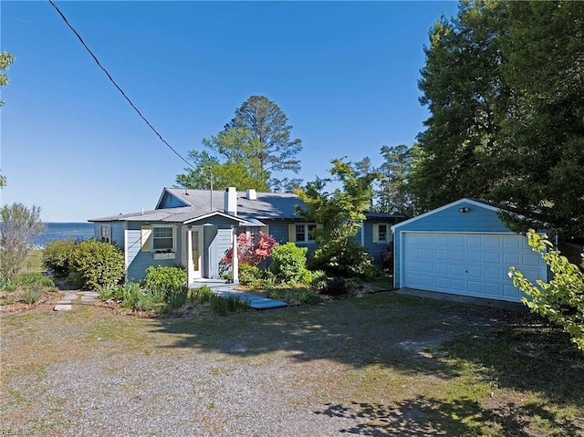 view of front of property featuring a garage and an outbuilding