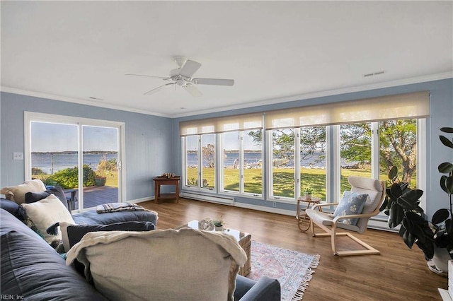 sunroom featuring a baseboard heating unit and visible vents