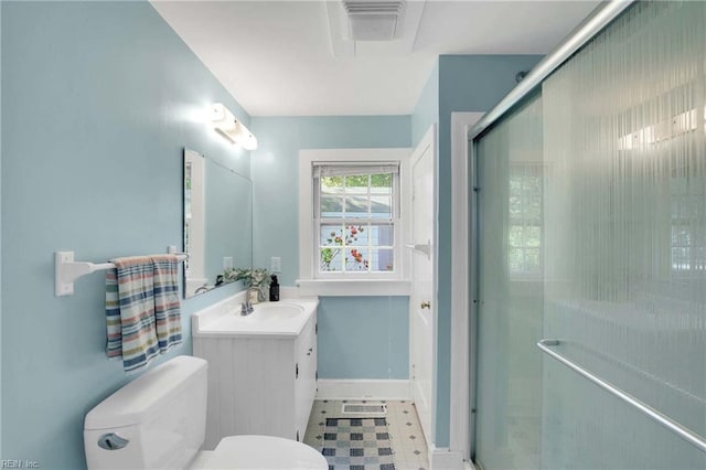 full bath with vanity, baseboards, a shower with shower door, and toilet